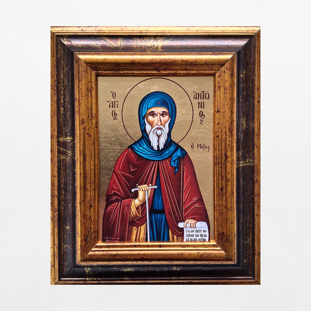 Ikone des Heiligen Antonius im verzierten Holzrahmen vor weißem Hintergrund.